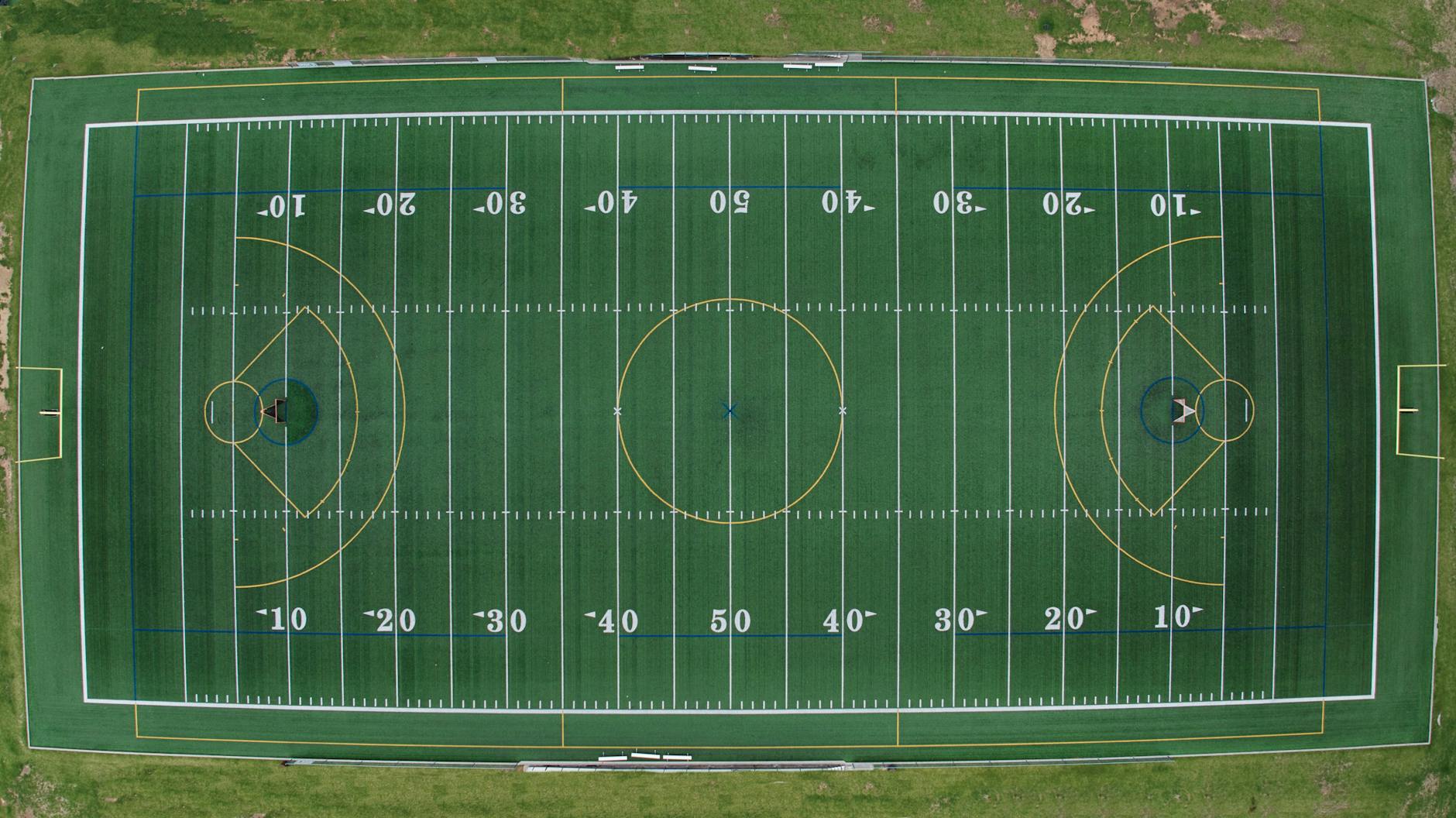 Aerial view of a multi-sport field featuring football and soccer markings.