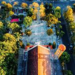 Drone shot of Phương Nghĩa Church amidst vibrant greenery in Kon Tum, Vietnam.