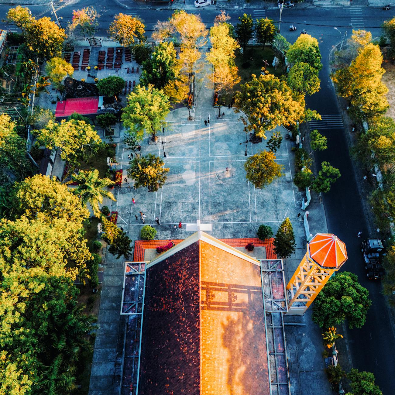 Drone shot of Phương Nghĩa Church amidst vibrant greenery in Kon Tum, Vietnam.